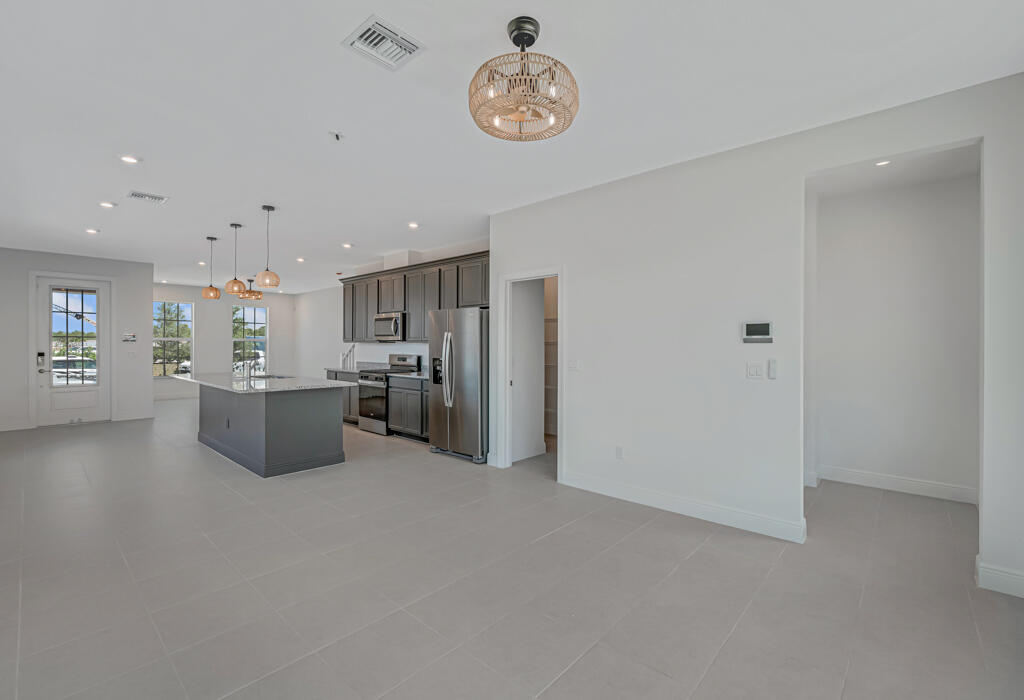 930 Southwest Pr Avenue Palm City, FL 34990 - Photo 10 of 66 a open kitchen with a refrigerator a microwave and a stove