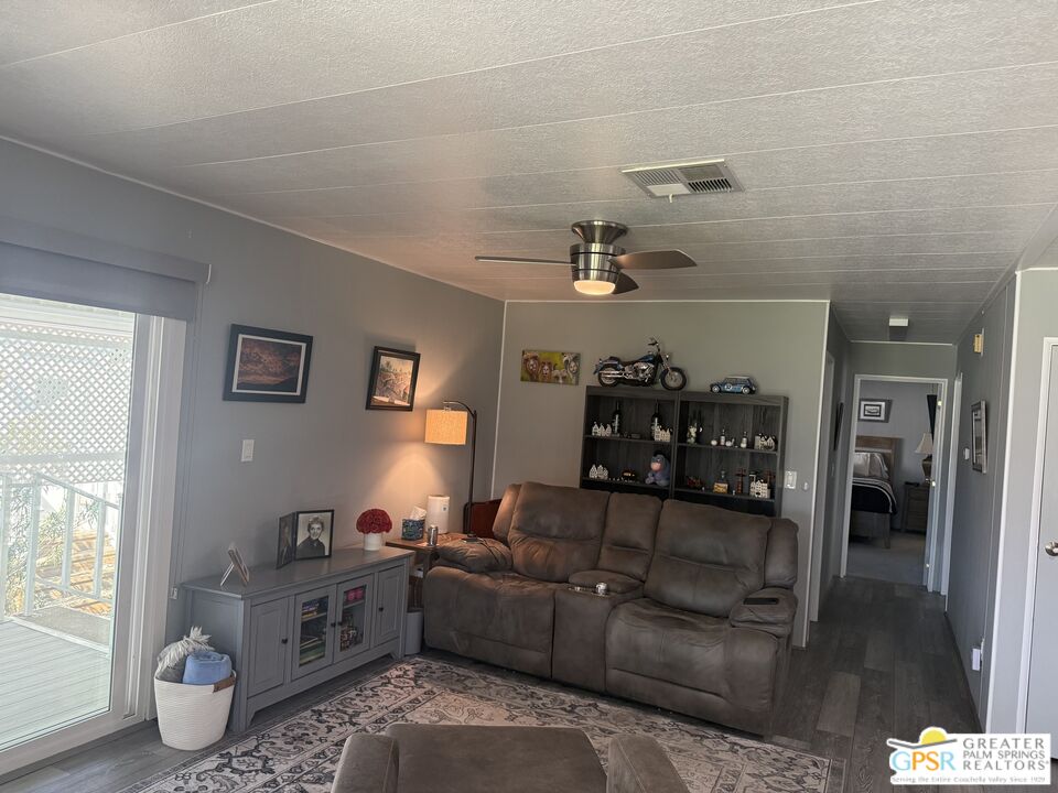 15500 Bubbling Wells Road, Unit 286 Desert Hot Springs, CA 92240 - Photo 14 of 50 a living room with furniture and chandelier