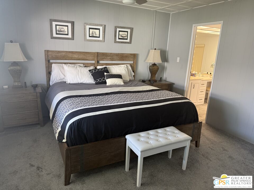 15500 Bubbling Wells Road, Unit 286 Desert Hot Springs, CA 92240 - Photo 16 of 50 a bedroom with a bed and wooden floor