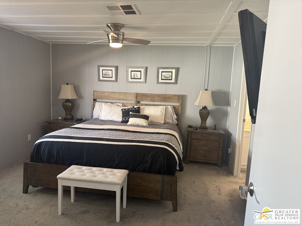 15500 Bubbling Wells Road, Unit 286 Desert Hot Springs, CA 92240 - Photo 17 of 50 a bedroom with a bed and a chair