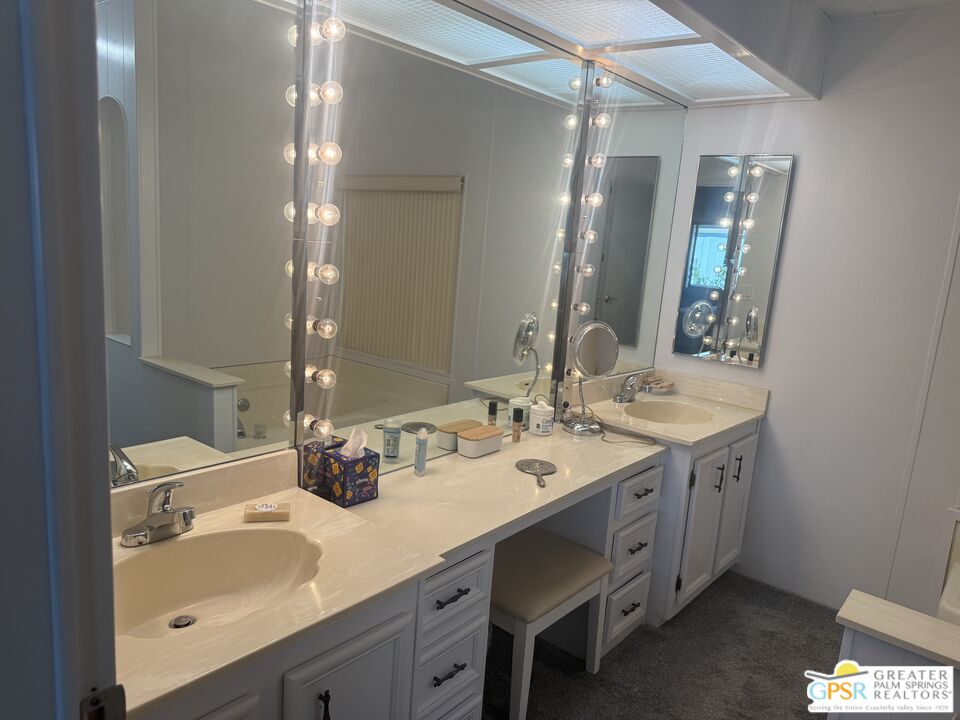 15500 Bubbling Wells Road, Unit 286 Desert Hot Springs, CA 92240 - Photo 19 of 50 a bathroom with a double vanity sink and a mirror