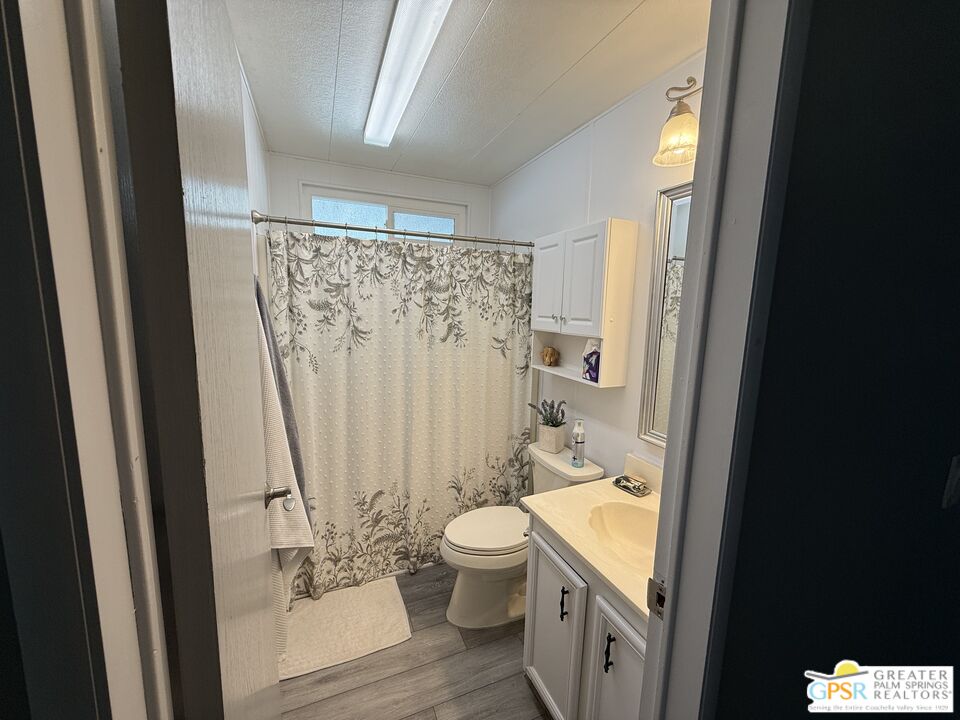 15500 Bubbling Wells Road, Unit 286 Desert Hot Springs, CA 92240 - Photo 21 of 50 a bathroom with a granite countertop sink toilet and shower