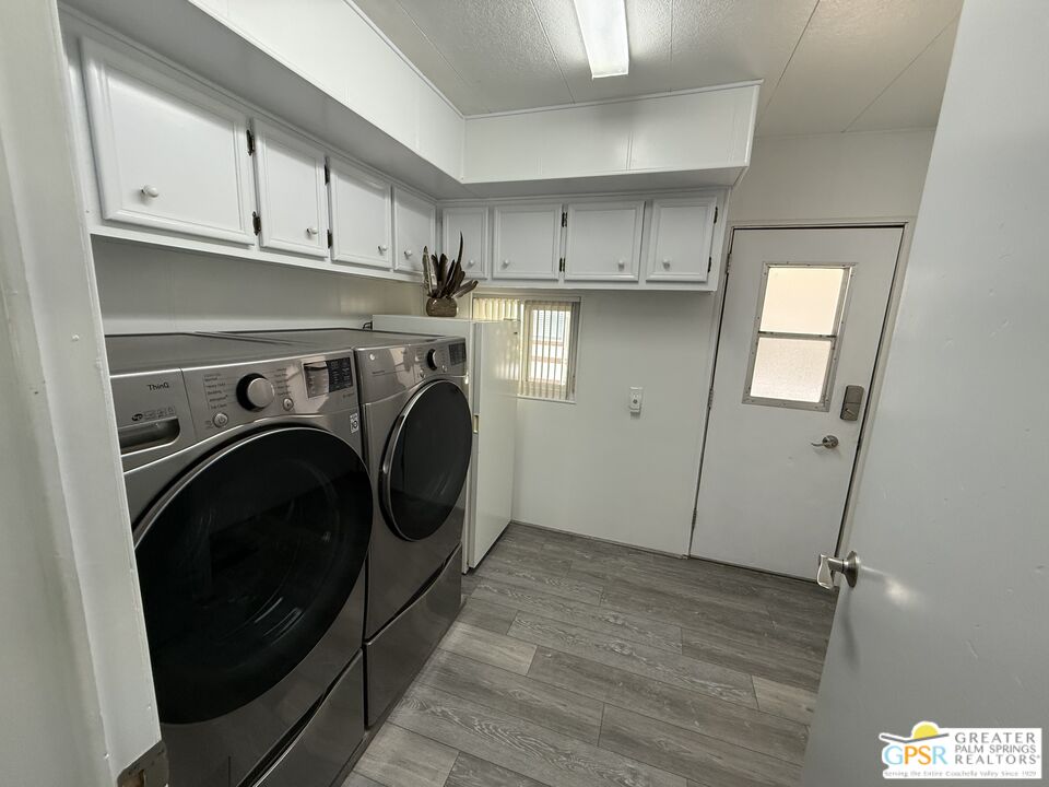 15500 Bubbling Wells Road, Unit 286 Desert Hot Springs, CA 92240 - Photo 22 of 50 a utility room with sink dryer and washer