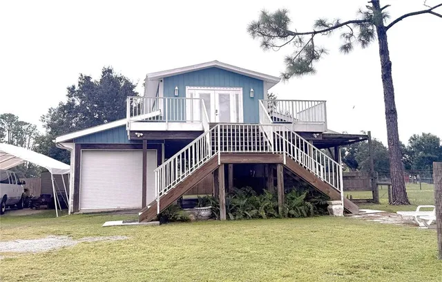 a view of a house with a swimming pool and deck