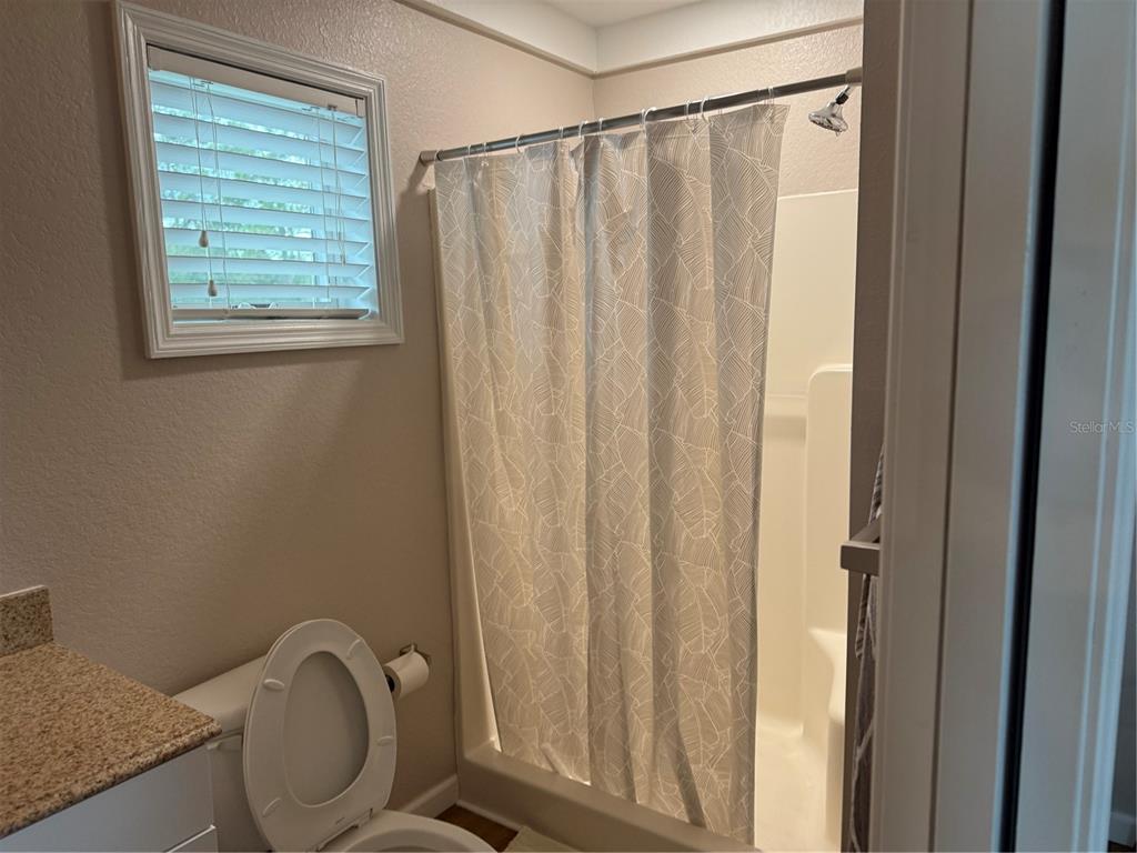 1470 Nestor Court North Port, FL 34286 - Photo 7 of 13 a bathroom with a granite countertop toilet and a shower curtain