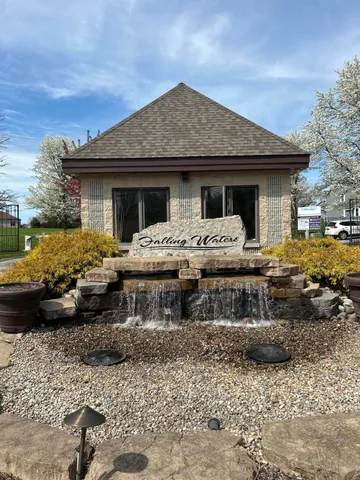 a front view of a house with yard porch and furniture