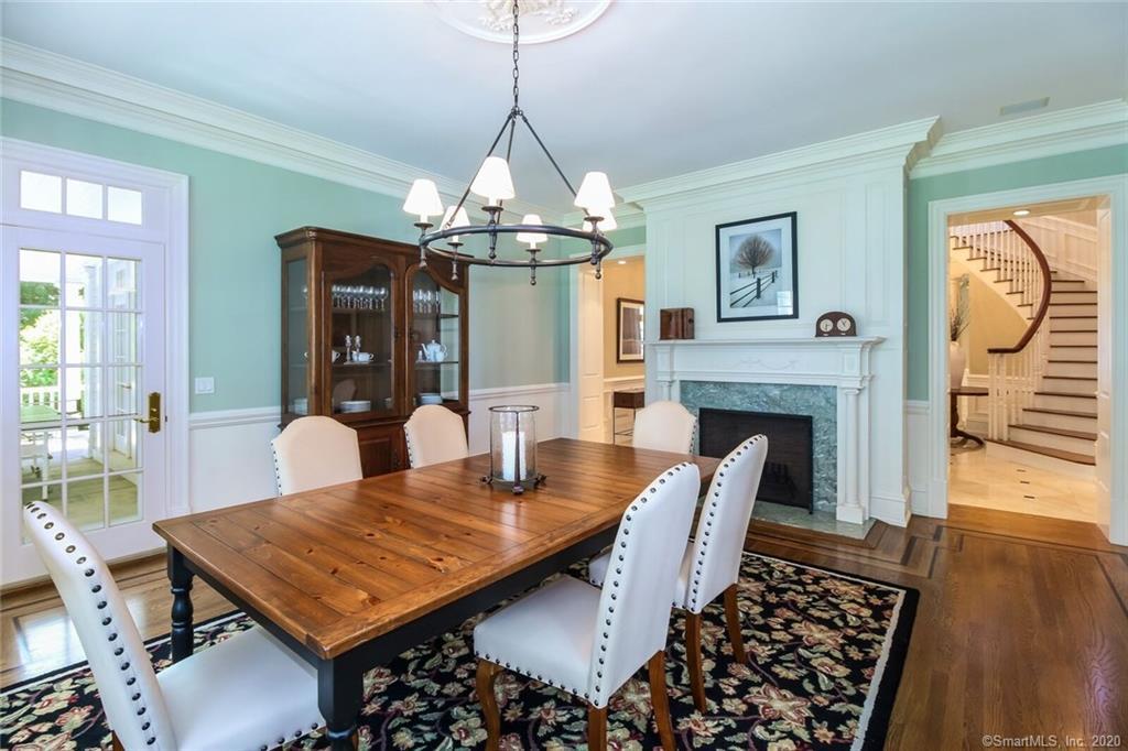 83 Lukes Wood Road New Canaan, CT 06840 - Photo 11 of 51 a view of a dining room with furniture wooden floor and chandelier