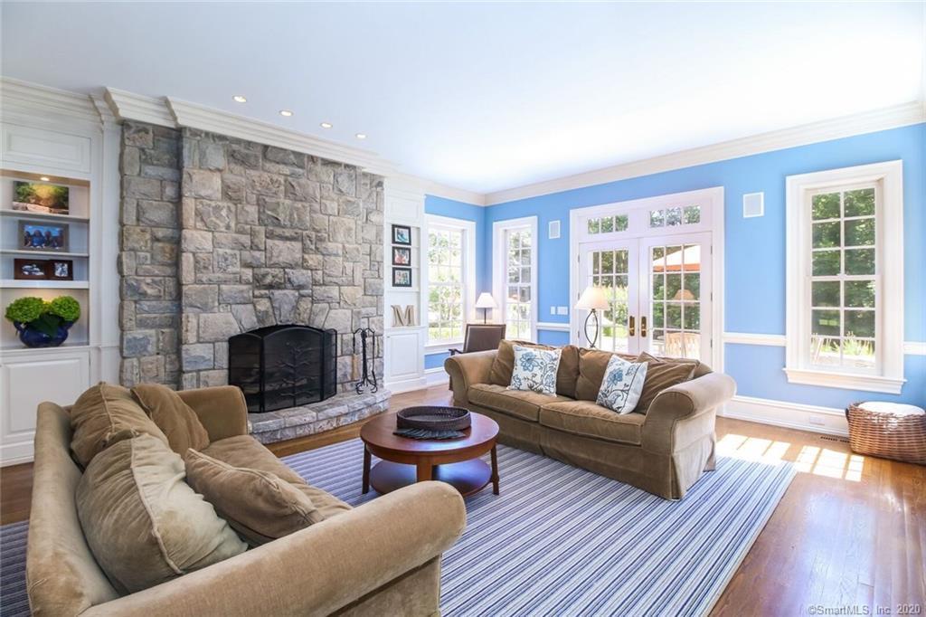 83 Lukes Wood Road New Canaan, CT 06840 - Photo 13 of 51 a living room with furniture a fireplace and a large window