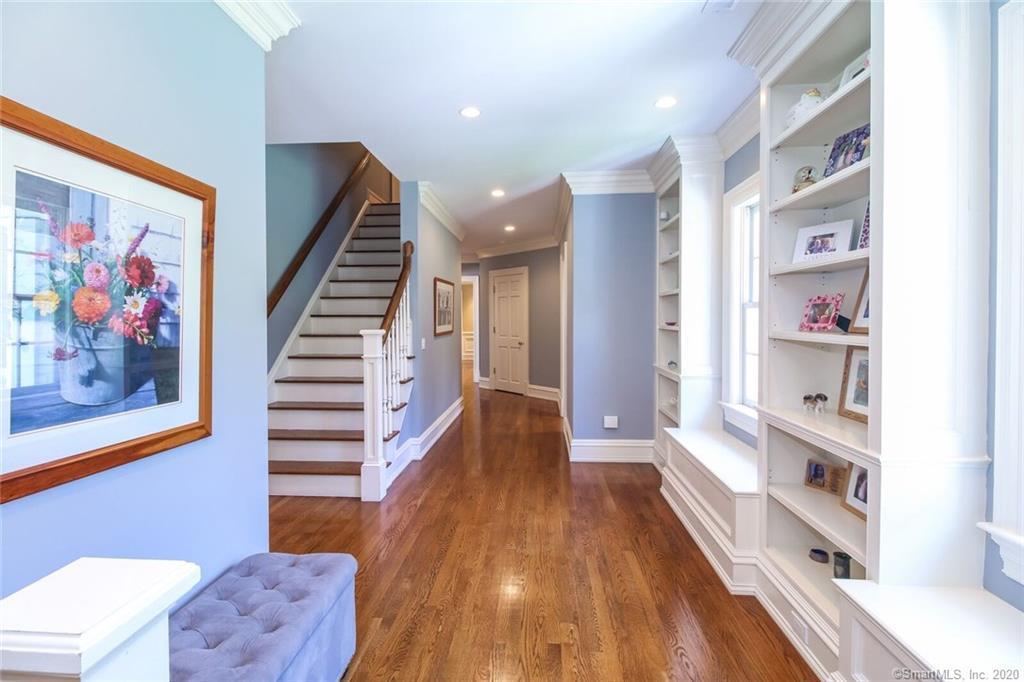 83 Lukes Wood Road New Canaan, CT 06840 - Photo 26 of 51 a view of a hallway with wooden floor and furniture