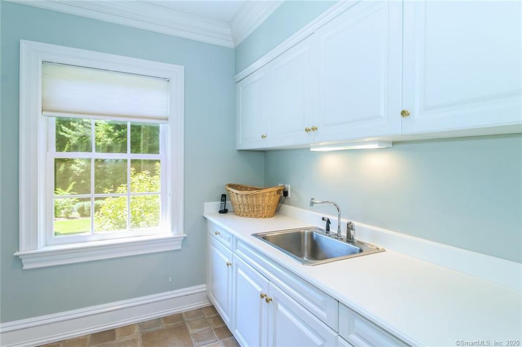 83 Lukes Wood Road New Canaan, CT 06840 - Photo 27 of 51 a kitchen with stainless steel appliances granite countertop a sink a window and cabinets