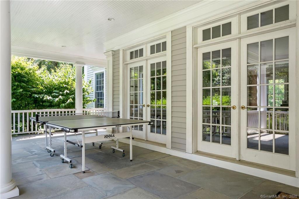83 Lukes Wood Road New Canaan, CT 06840 - Photo 35 of 51 a dining room with wooden floor and furniture