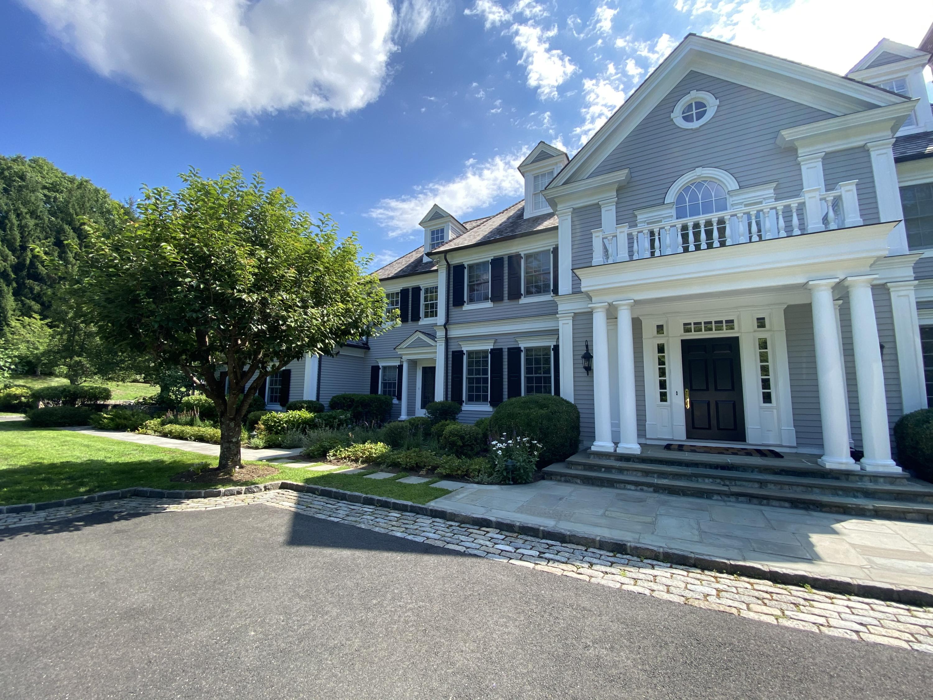83 Lukes Wood Road New Canaan, CT 06840 - Photo 39 of 51 a front view of a house with garden
