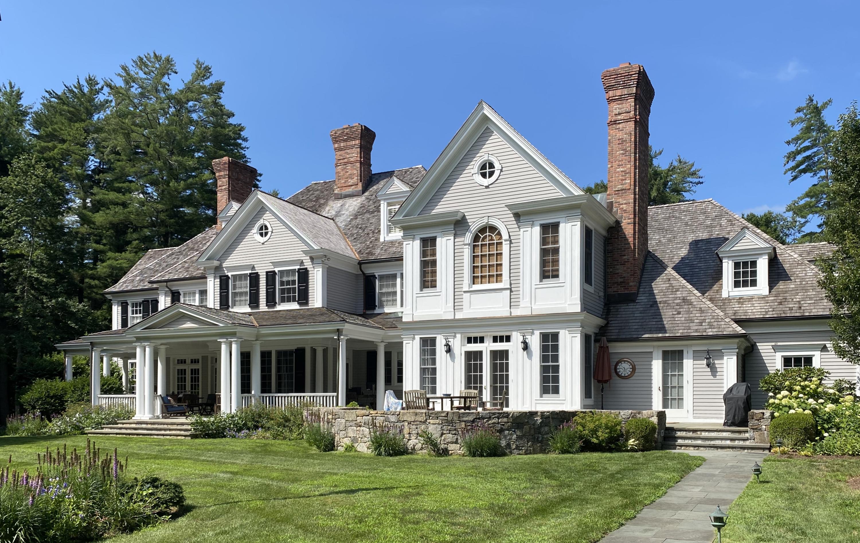 83 Lukes Wood Road New Canaan, CT 06840 - Photo 43 of 51 a front view of a house with a yard