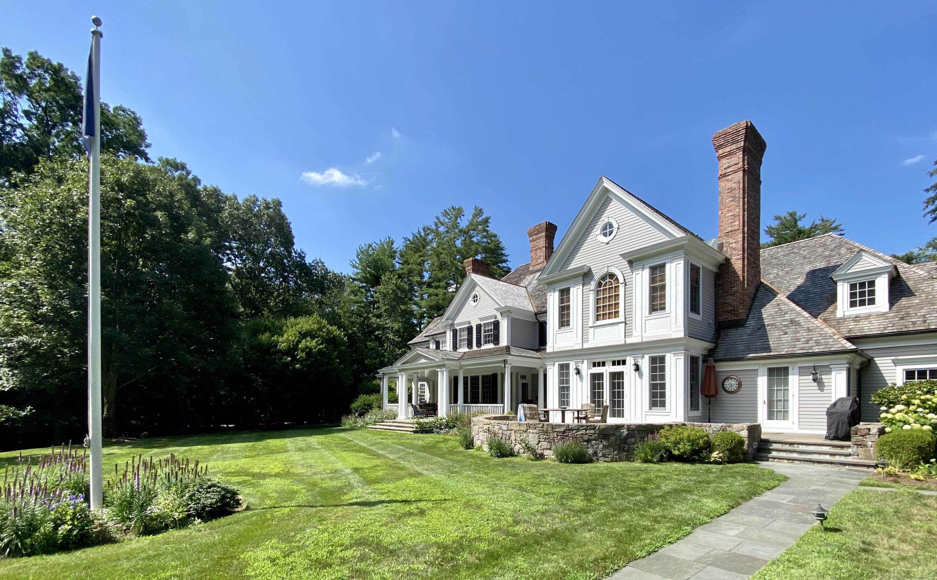 83 Lukes Wood Road New Canaan, CT 06840 - Photo 44 of 51 a front view of a house with garden