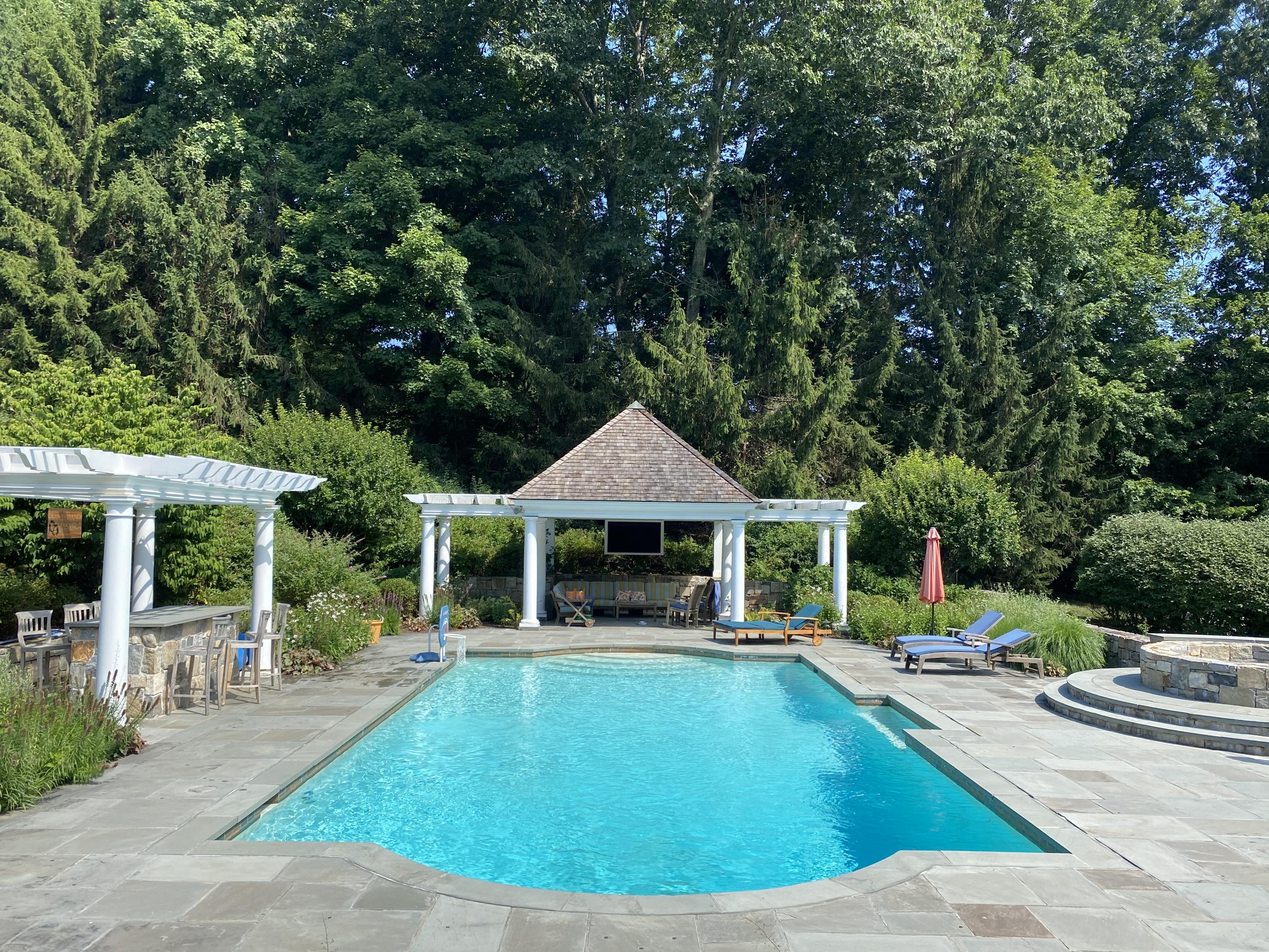83 Lukes Wood Road New Canaan, CT 06840 - Photo 49 of 51 a view of a house with swimming pool and porch