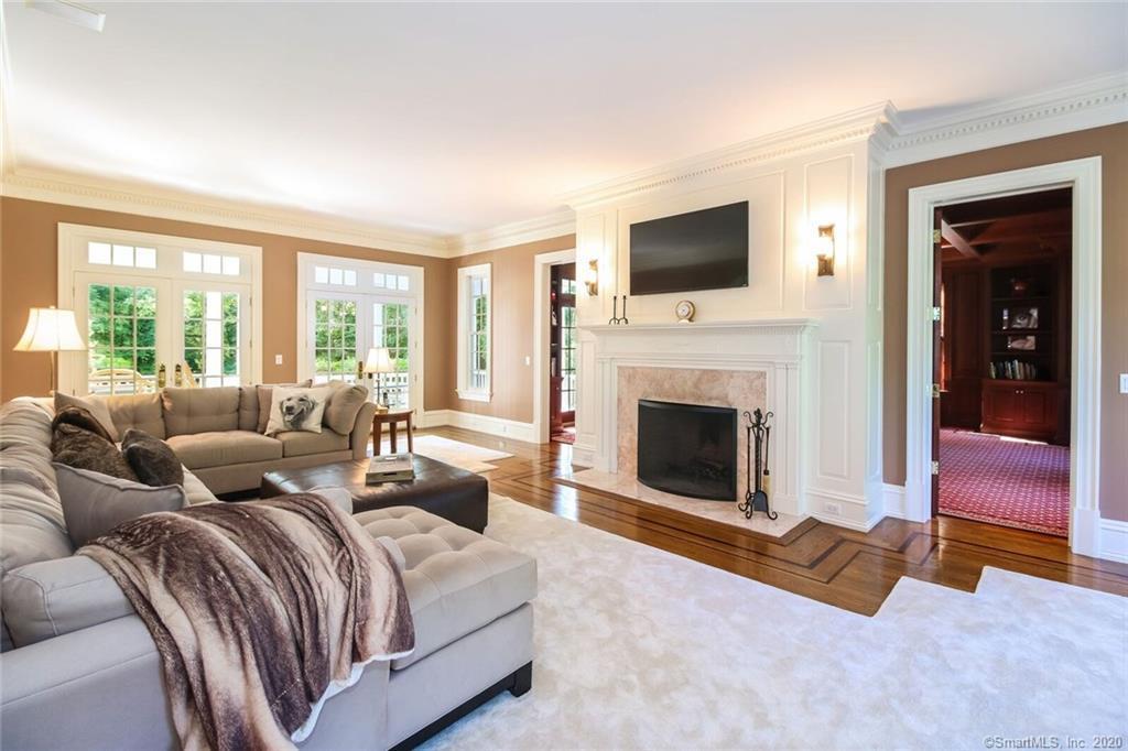 83 Lukes Wood Road New Canaan, CT 06840 - Photo 6 of 51 a living room with a flat screen tv and a fireplace