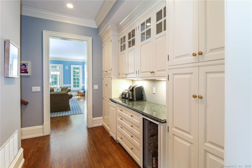 83 Lukes Wood Road New Canaan, CT 06840 - Photo 8 of 51 a kitchen with stainless steel appliances granite countertop a refrigerator and a view of living room