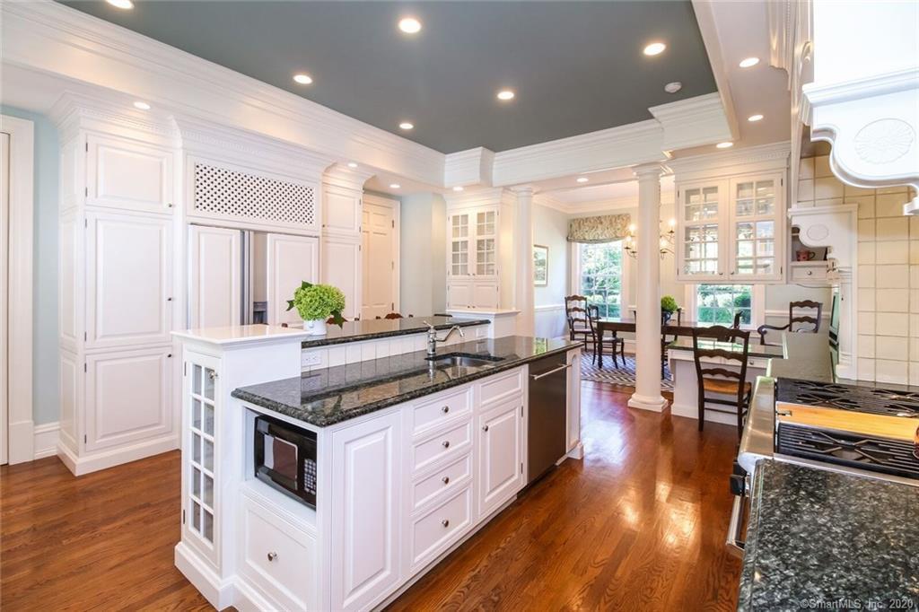 83 Lukes Wood Road New Canaan, CT 06840 - Photo 9 of 51 a kitchen with stainless steel appliances granite countertop a stove and a large window