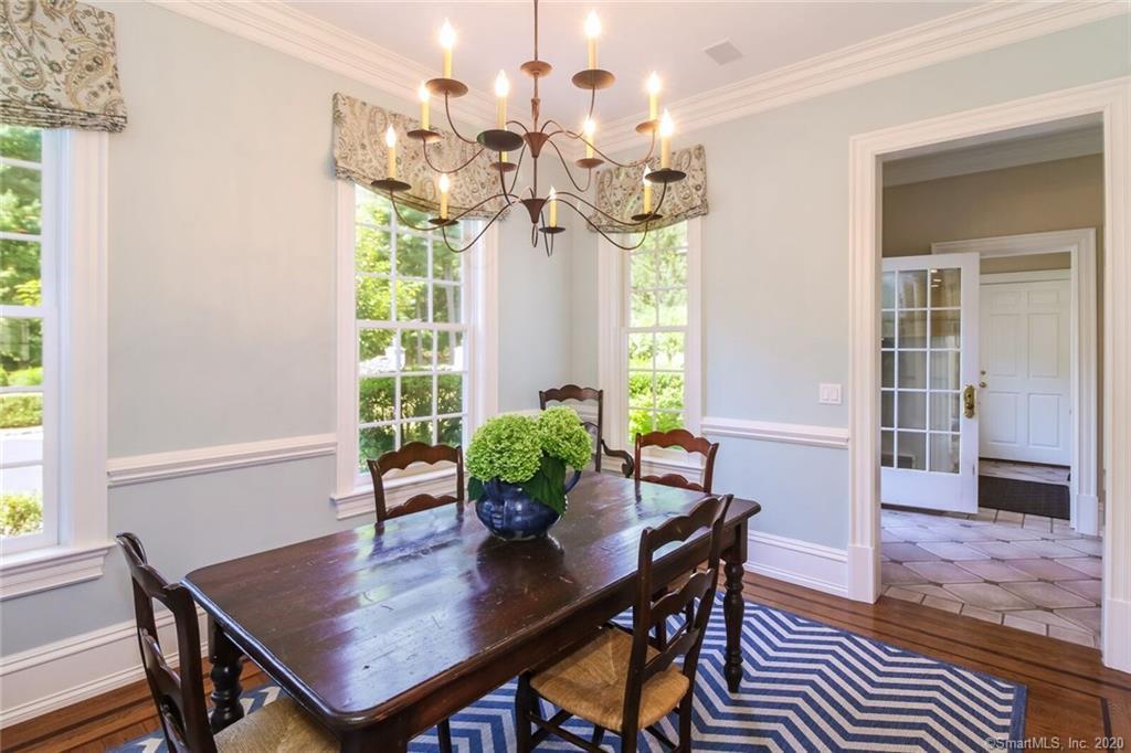 83 Lukes Wood Road New Canaan, CT 06840 - Photo 10 of 51 a view of a dining room with furniture and a potted plant