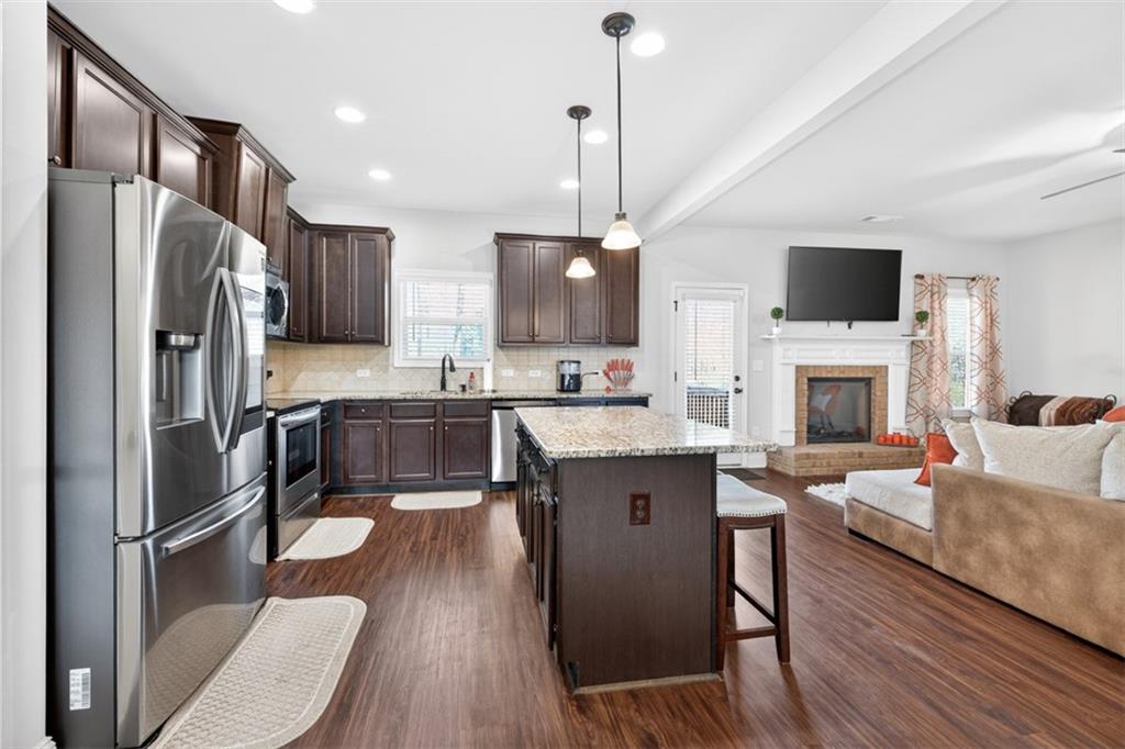 860 Tranquil Way Hampton, GA 30228 - Photo 19 of 54 a kitchen with stainless steel appliances granite countertop a refrigerator a stove top oven a sink dishwasher and a refrigerator