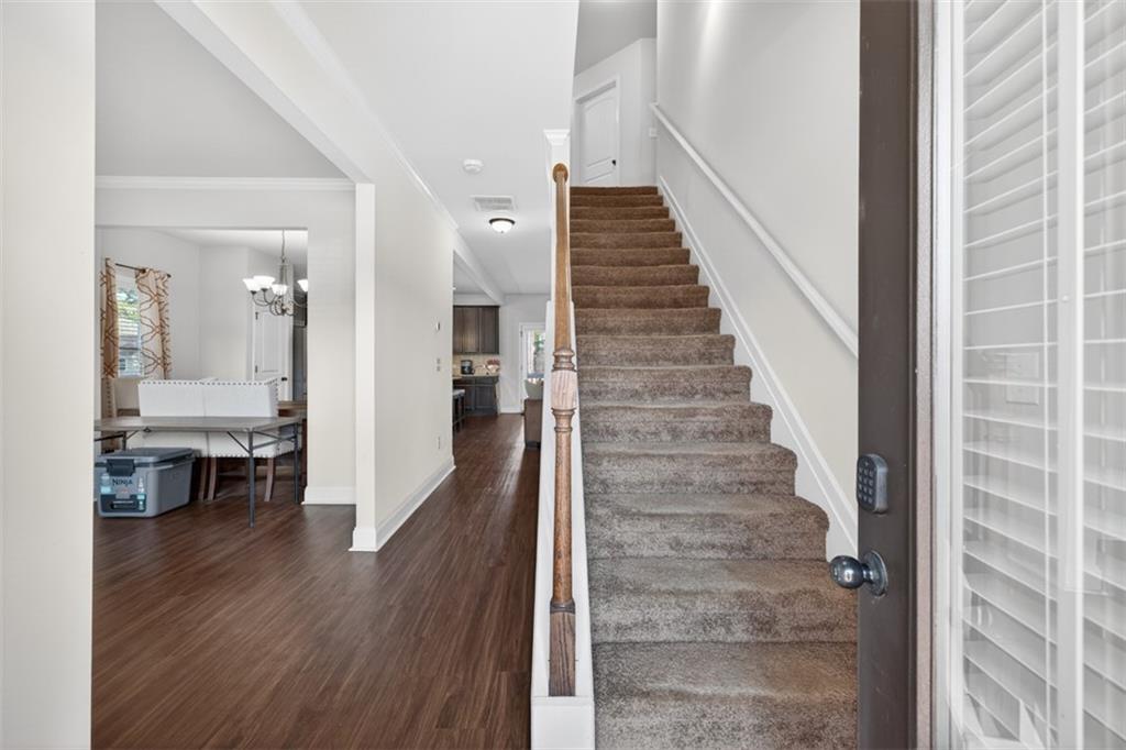 860 Tranquil Way Hampton, GA 30228 - Photo 2 of 54 a view of a hallway view with wooden floor and staircase