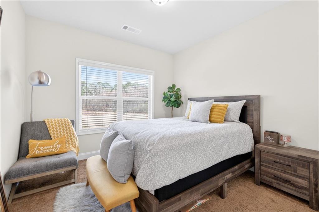 860 Tranquil Way Hampton, GA 30228 - Photo 21 of 54 a bed room with a bed and a couch