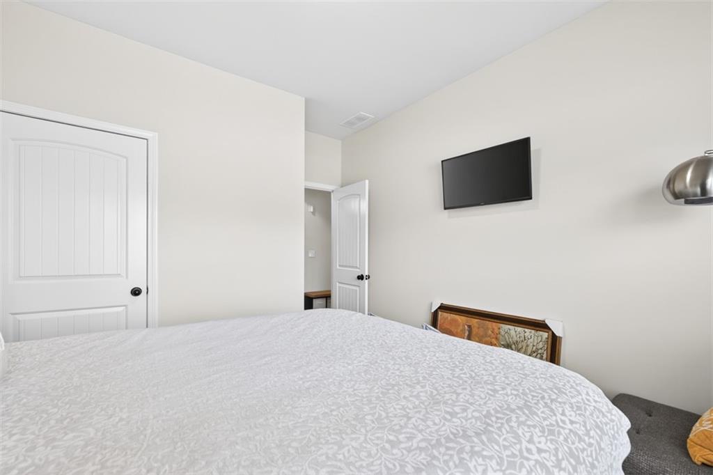 860 Tranquil Way Hampton, GA 30228 - Photo 22 of 54 a bedroom with a bed and a flat screen tv