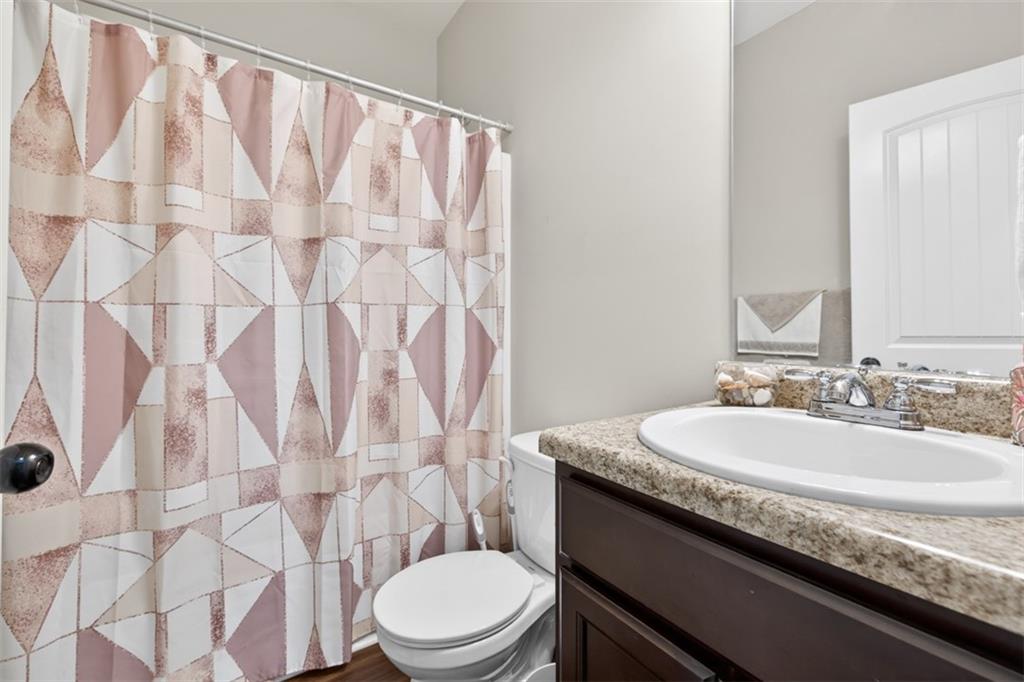 860 Tranquil Way Hampton, GA 30228 - Photo 23 of 54 a bathroom with a granite countertop sink and a mirror