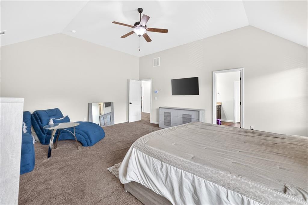 860 Tranquil Way Hampton, GA 30228 - Photo 27 of 54 a spacious bedroom with a bed and a chair