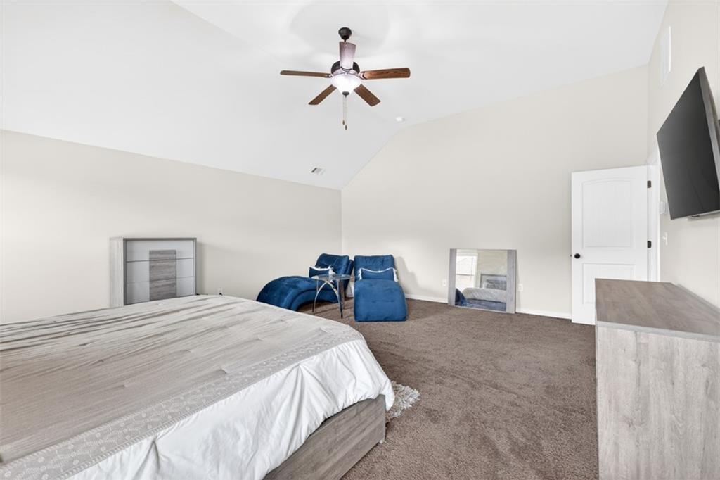 860 Tranquil Way Hampton, GA 30228 - Photo 28 of 54 a bedroom with a bed and a flat screen tv