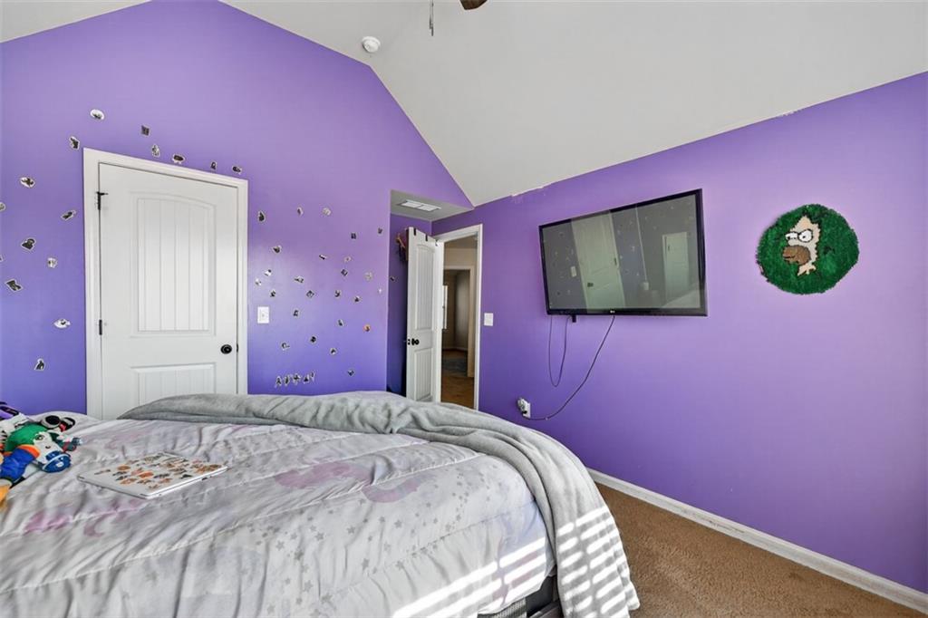 860 Tranquil Way Hampton, GA 30228 - Photo 36 of 54 a bedroom with a bed and a flat screen tv