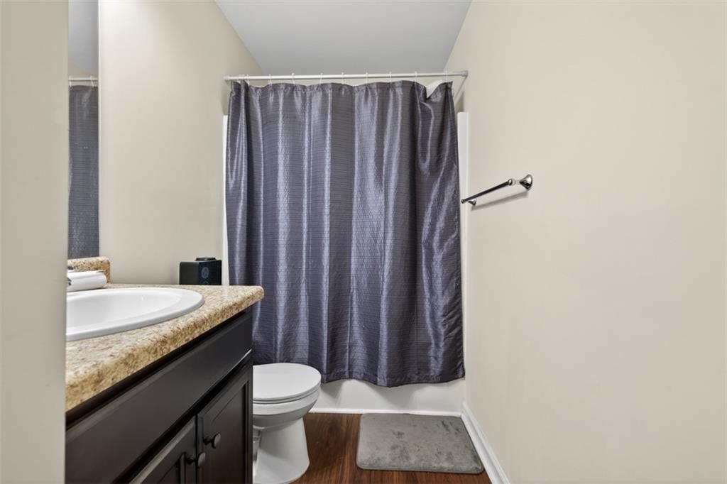 860 Tranquil Way Hampton, GA 30228 - Photo 43 of 54 a bathroom with a granite countertop sink and a toilet