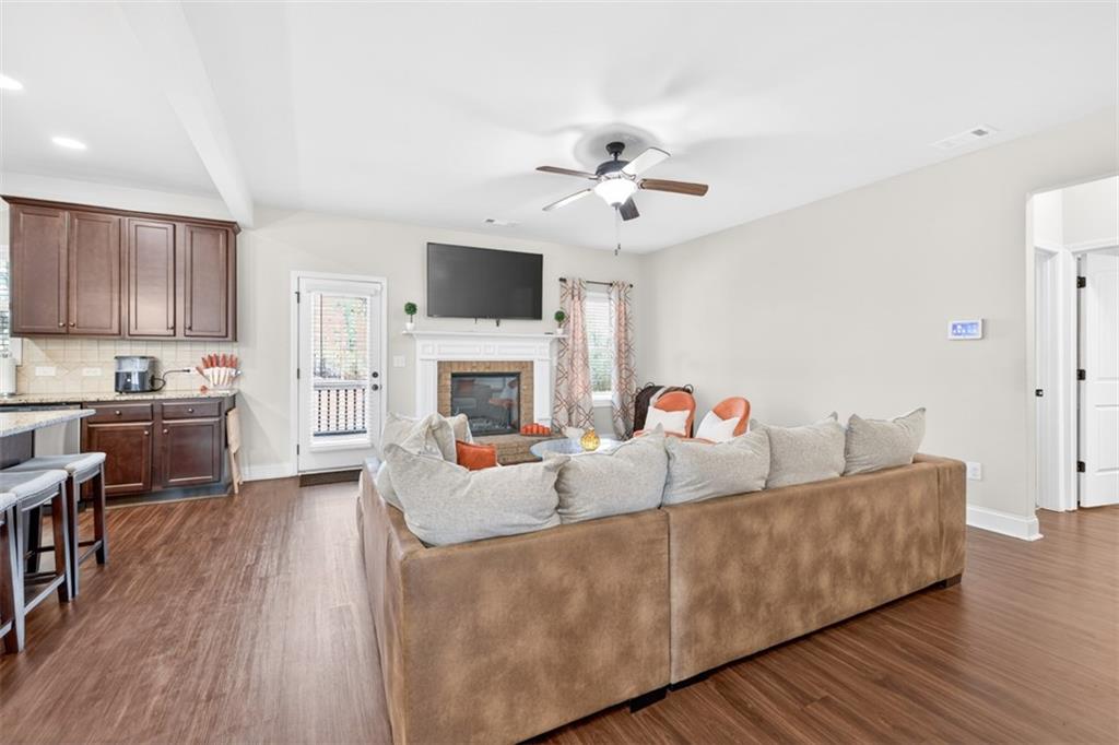 860 Tranquil Way Hampton, GA 30228 - Photo 8 of 54 a living room with furniture a fireplace and a flat screen tv