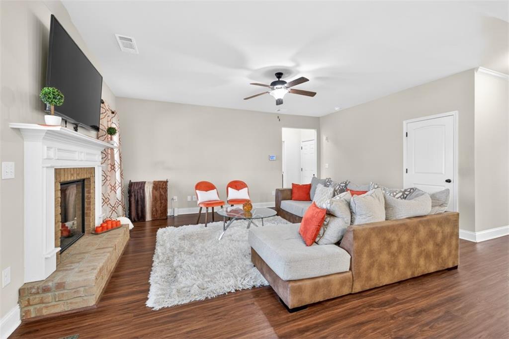 860 Tranquil Way Hampton, GA 30228 - Photo 9 of 54 a living room with furniture fireplace and wooden floor