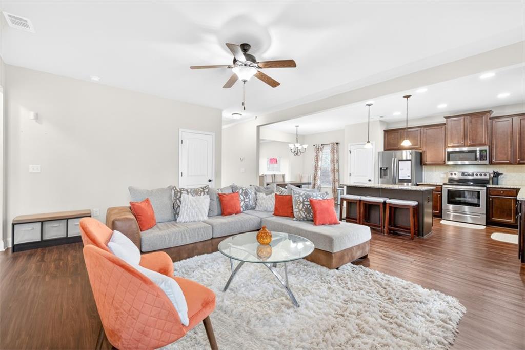860 Tranquil Way Hampton, GA 30228 - Photo 10 of 54 a living room with furniture kitchen view and a wooden floor