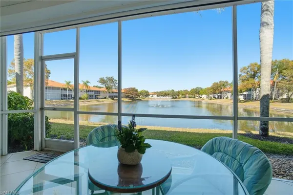 a view of a balcony with lake view and a potted plant