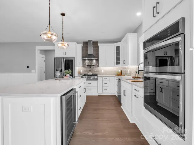 a kitchen with cabinets a sink and stainless steel appliances