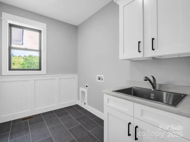 a kitchen with white cabinets and a sink