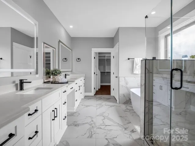 a large bathroom with a granite countertop sink mirror and a shower