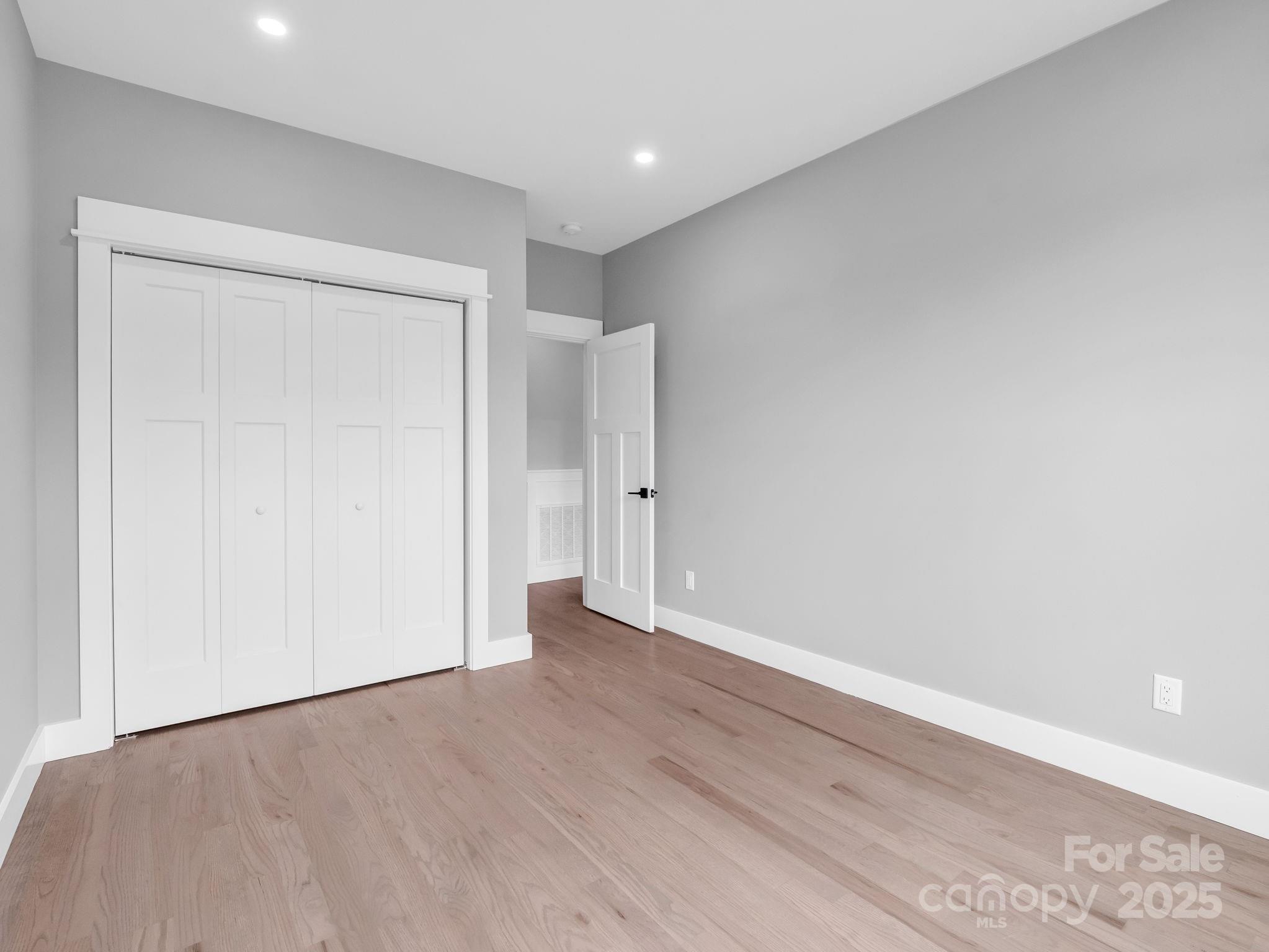 128 Gravely Branch Road Fletcher, NC 28732 - Photo 29 of 48 an empty room with wooden floor and closet