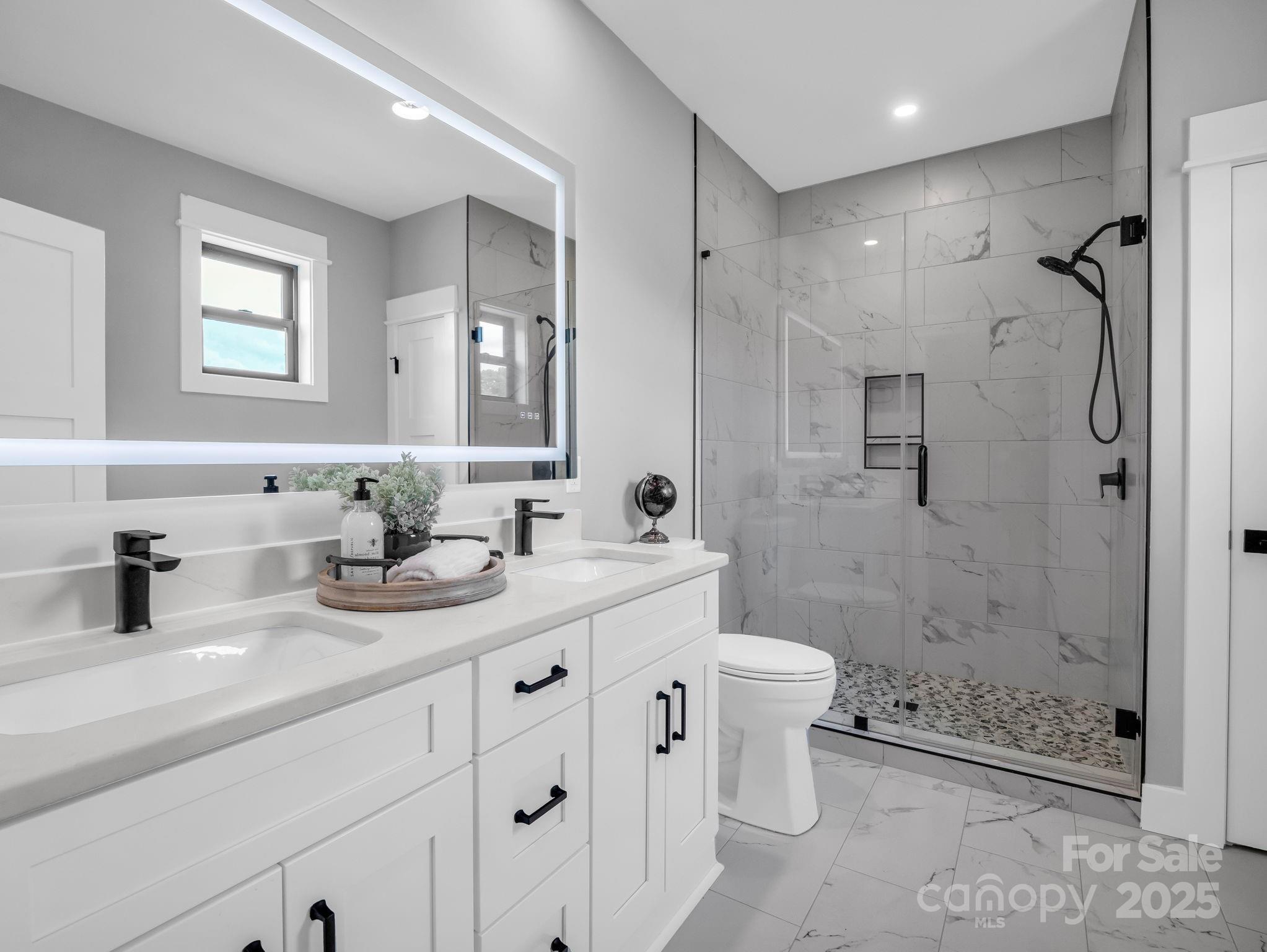 128 Gravely Branch Road Fletcher, NC 28732 - Photo 33 of 48 a bathroom with double sink shower and a toilet