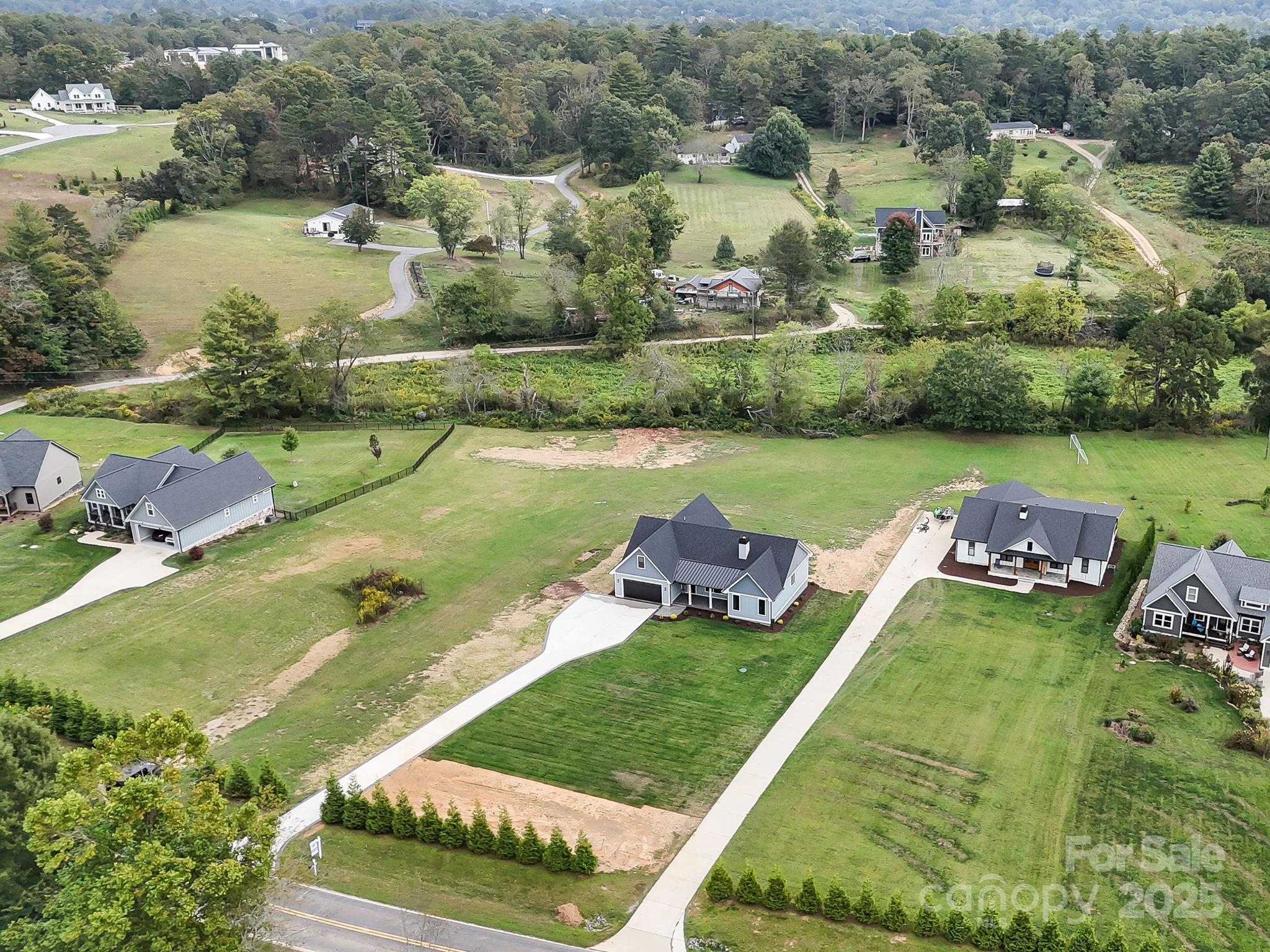 128 Gravely Branch Road Fletcher, NC 28732 - Photo 36 of 48 an aerial view of a house with a garden and lake view