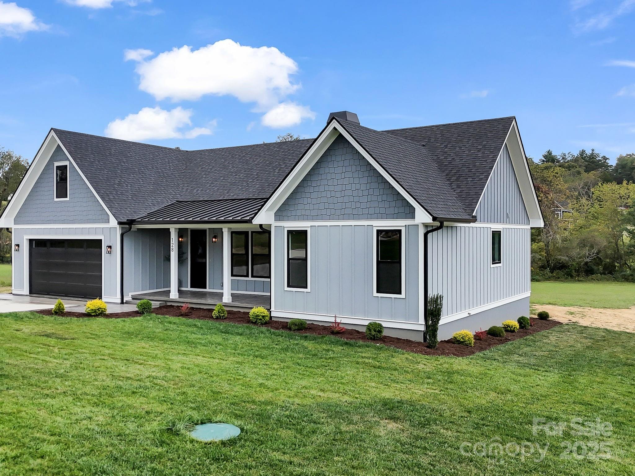 128 Gravely Branch Road Fletcher, NC 28732 - Photo 45 of 48 a front view of a house with a yard and garage