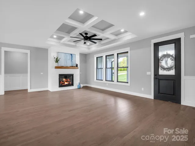 a view of an empty room with a fireplace and a window