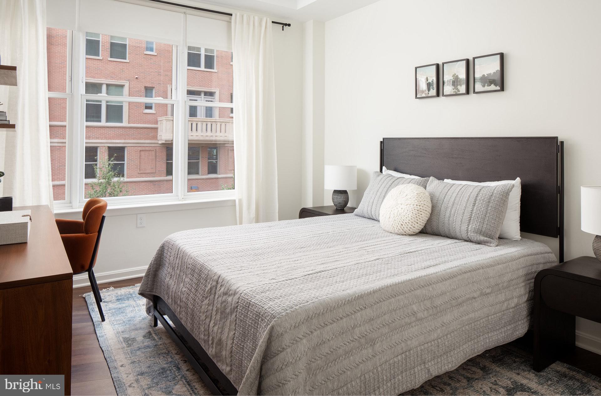 3820 Chaplin Place, Unit 550/CLAUDE Chevy Chase, MD 20815 - Photo 14 of 26 a bedroom with a bed and a table