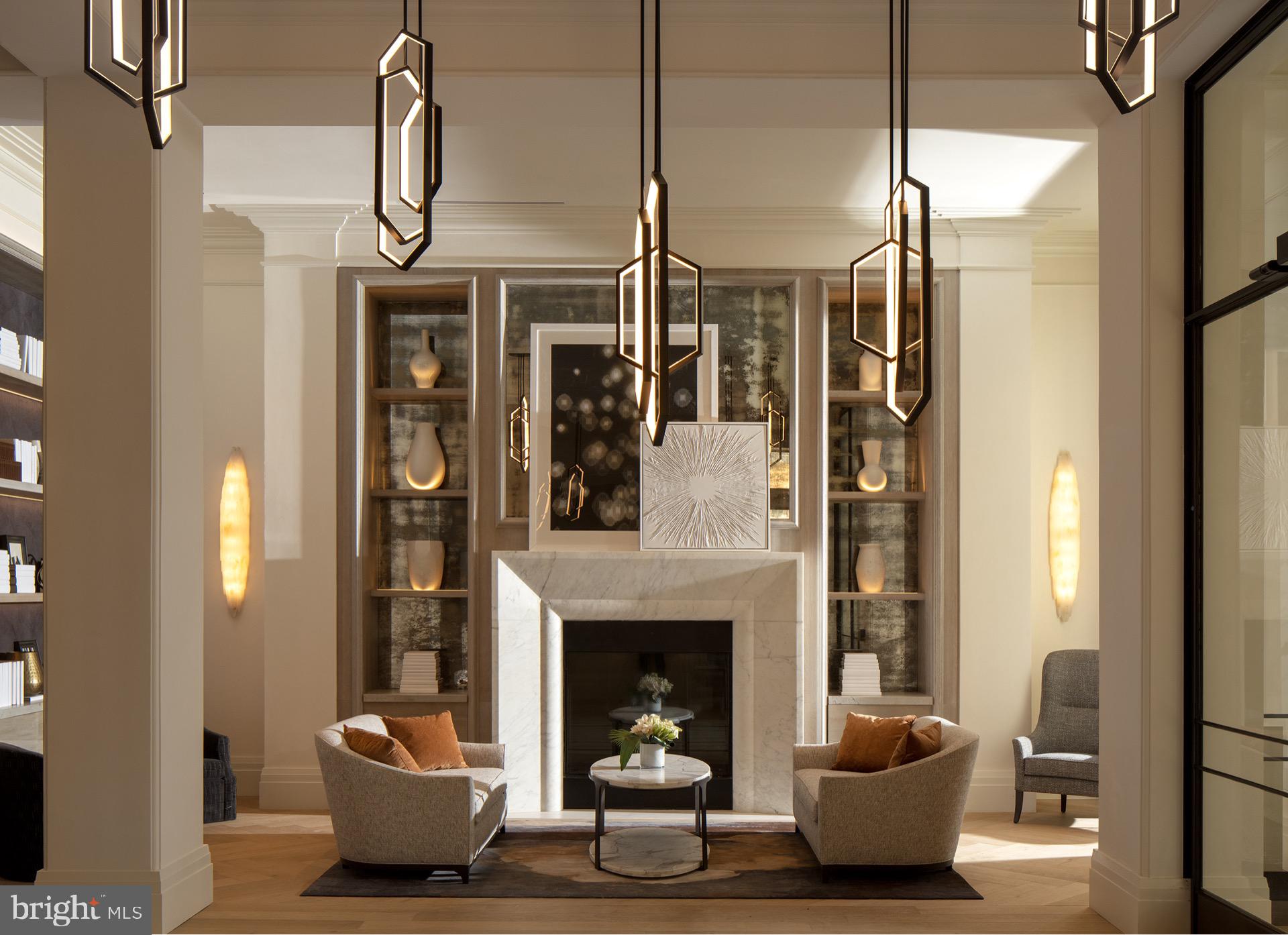 3820 Chaplin Place, Unit 550/CLAUDE Chevy Chase, MD 20815 - Photo 3 of 26 a living room with furniture a fireplace and a chandelier