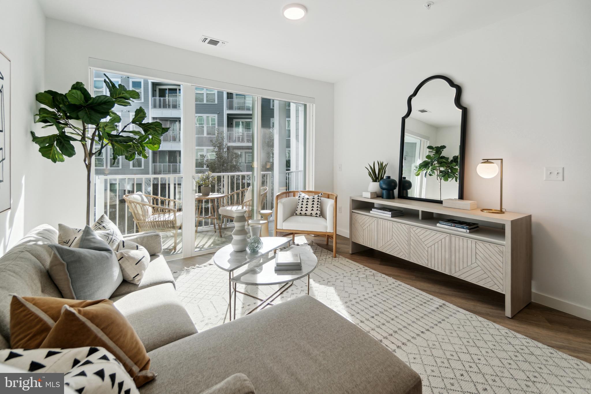 3820 Chaplin Place, Unit 550/CLAUDE Chevy Chase, MD 20815 - Photo 9 of 26 a living room with furniture and potted plant