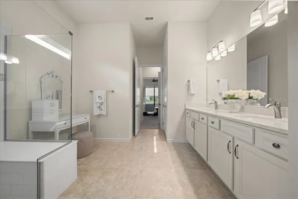 a kitchen with stainless steel appliances granite countertop a table chairs sink and microwave