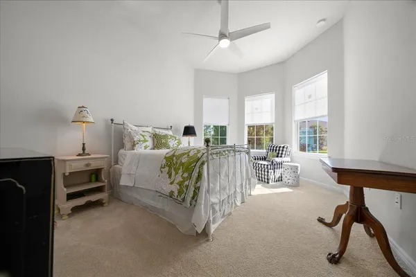 a bedroom with a bed and a table in it