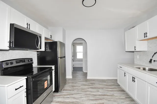 a kitchen with a sink stainless steel appliances and cabinets
